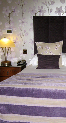 bedroom with floral wall covering